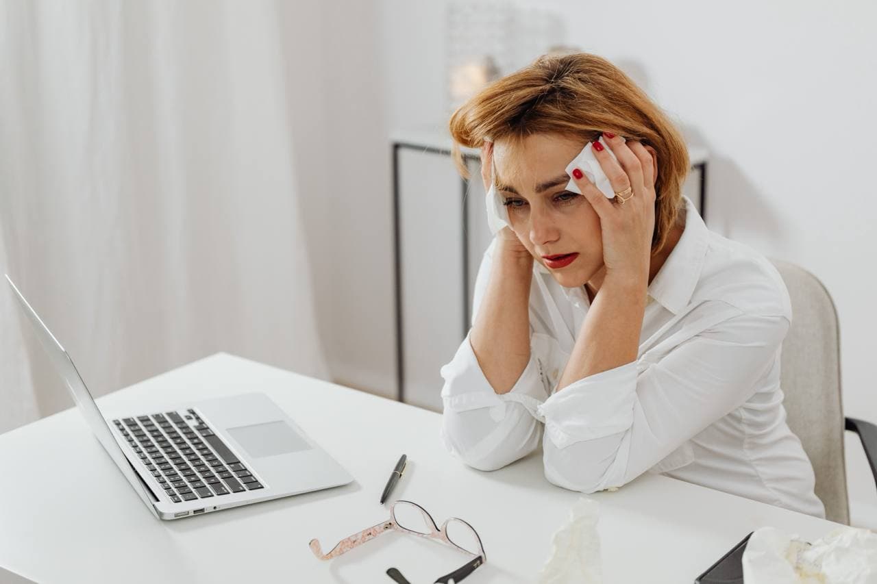 Business owner concerned while reviewing tax information on a laptop